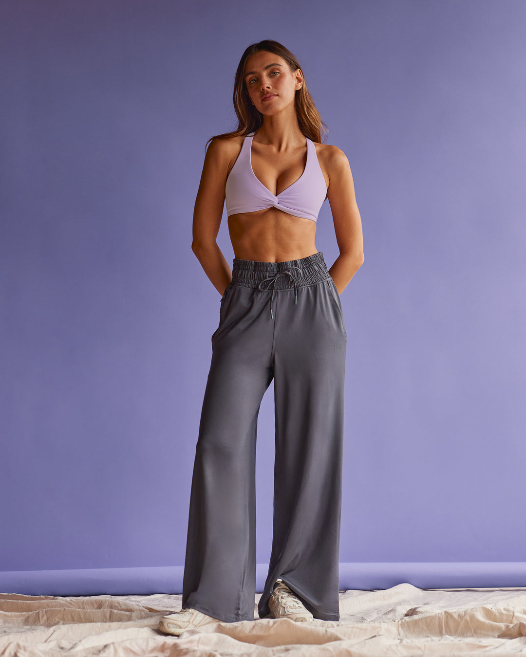 Woman wearing Aspire Twist Sports Bra - Pale Lilac | Model:Beatriz | Size:XS