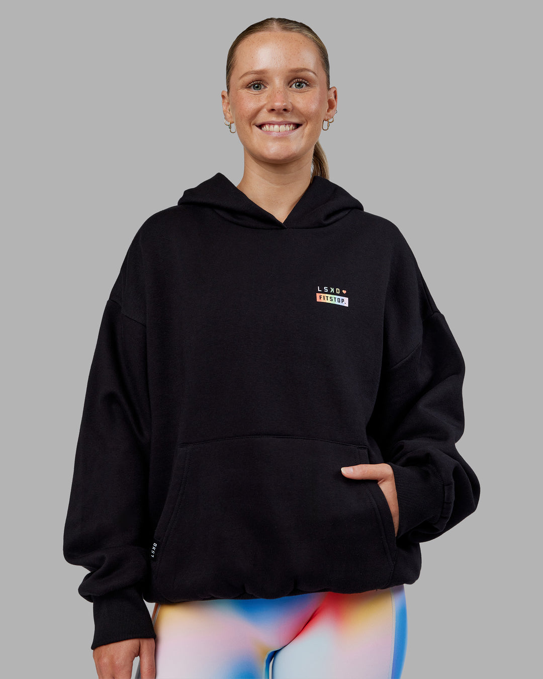 Woman wearing Fitstop Unstoppable Together Oversized Hoodie - Black | Model:Neve | Size:XS