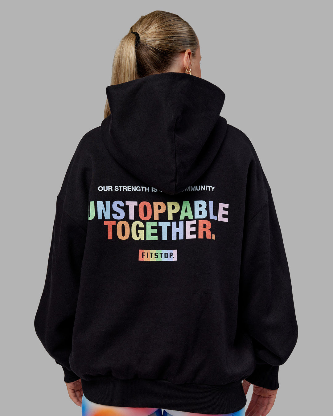 Woman wearing Fitstop Unstoppable Together Oversized Hoodie - Black | Model:Neve | Size:XS