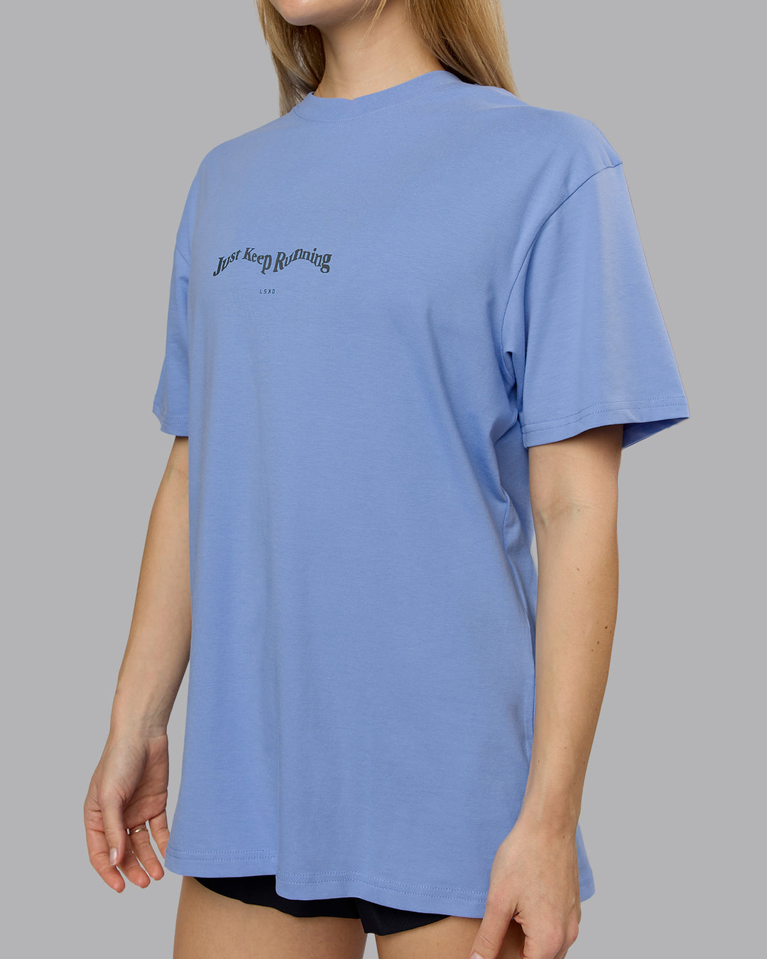 Woman wearing Just Run FLXCotton Oversized Tee - Soft Blue-Dark Storm | Model:Emilie | Size:XS