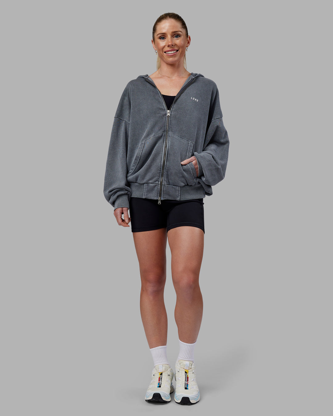 Woman wearing Relentless Washed Zip Through Oversized Hoodie - Dark Storm-White | Model:Kayti | Size:XS