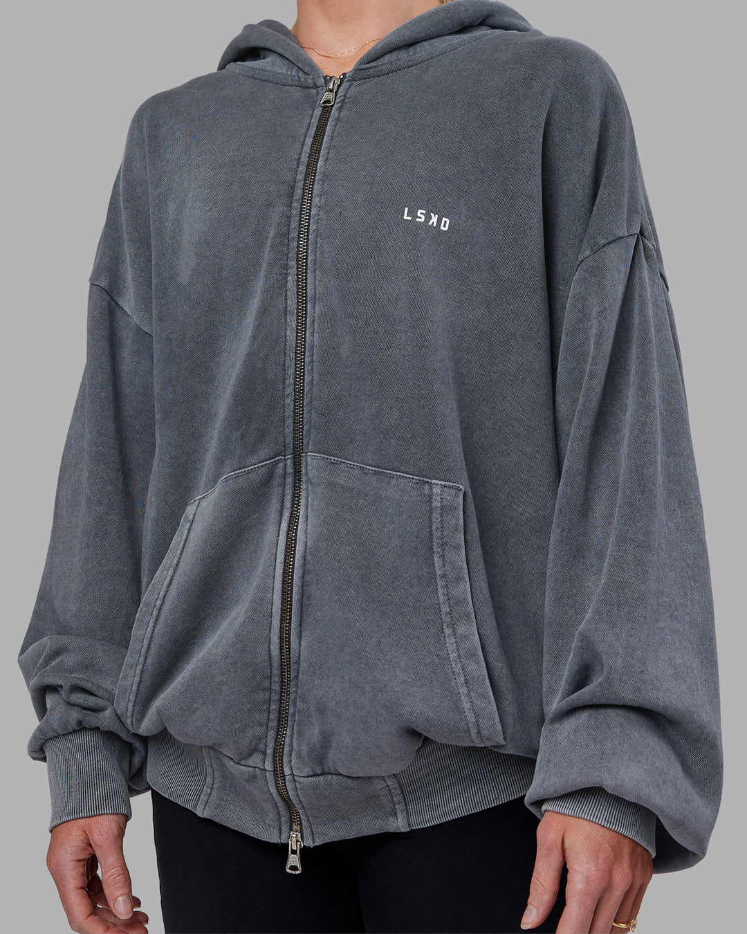 Woman wearing Relentless Washed Zip Through Oversized Hoodie - Dark Storm-White | Model:Kayti | Size:XS