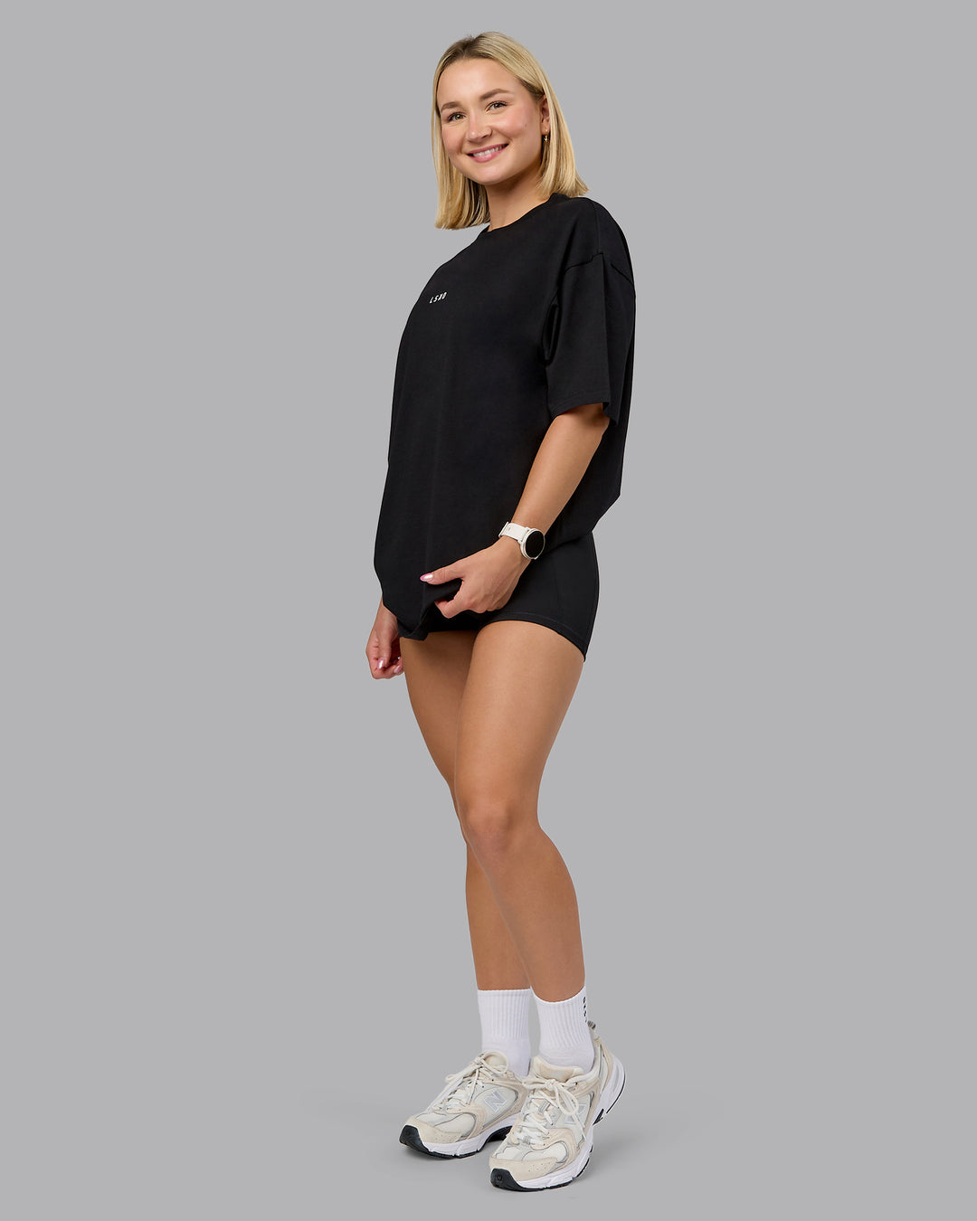 Woman wearing On Repeat FLXCotton Oversized Tee - Black-Mahogany | Model:Halle | Size:XS