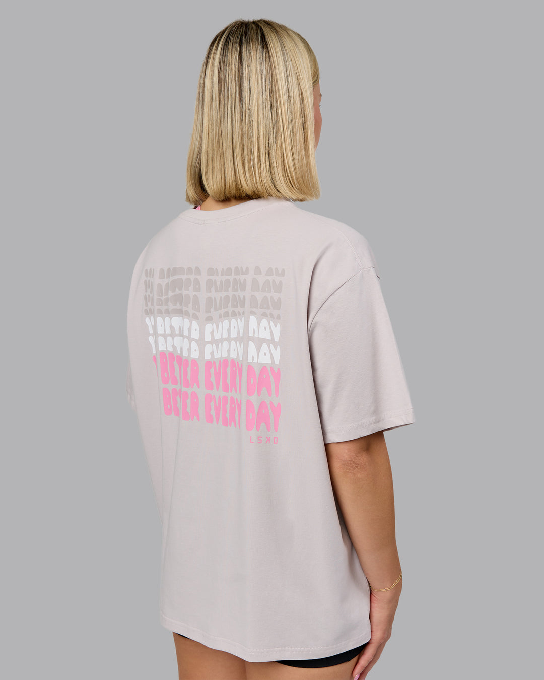 Woman wearing On Repeat FLXCotton Oversized Tee - Soft Grey-Candy Pink | Model:Halle | Size:S