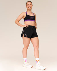 Woman wearing Velocity Graphic Sports Bra - Black-Radiate