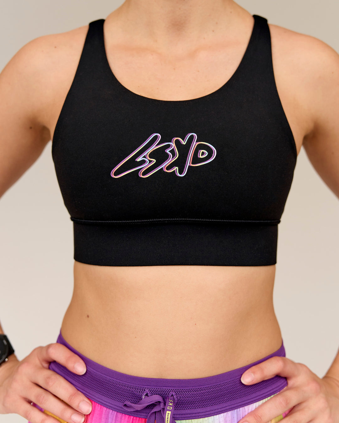 Woman wearing Accelerate Graphic Sports Bra - Black-Radiate