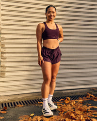 Woman wearing Accelerate 3" Mid-Rise Running Short - Cherry Lacquer
