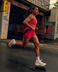 Woman wearing Accelerate 3" Mid-Rise Running Short - Cherry Lacquer-Scarlet