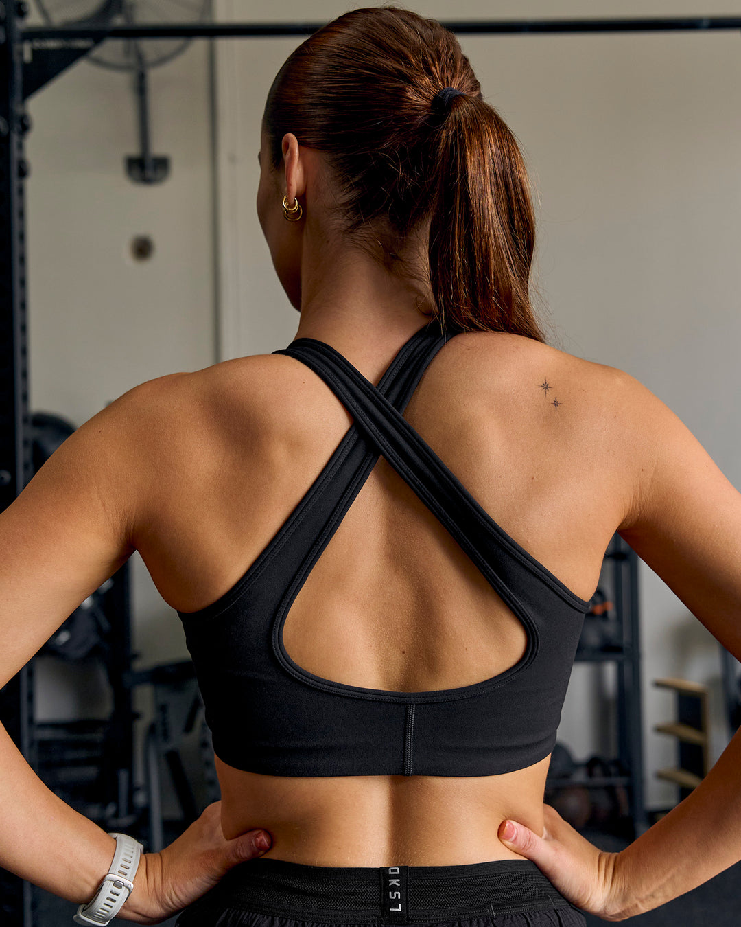 Woman wearing Stamina Amplify Sports Bra - Black - view 2