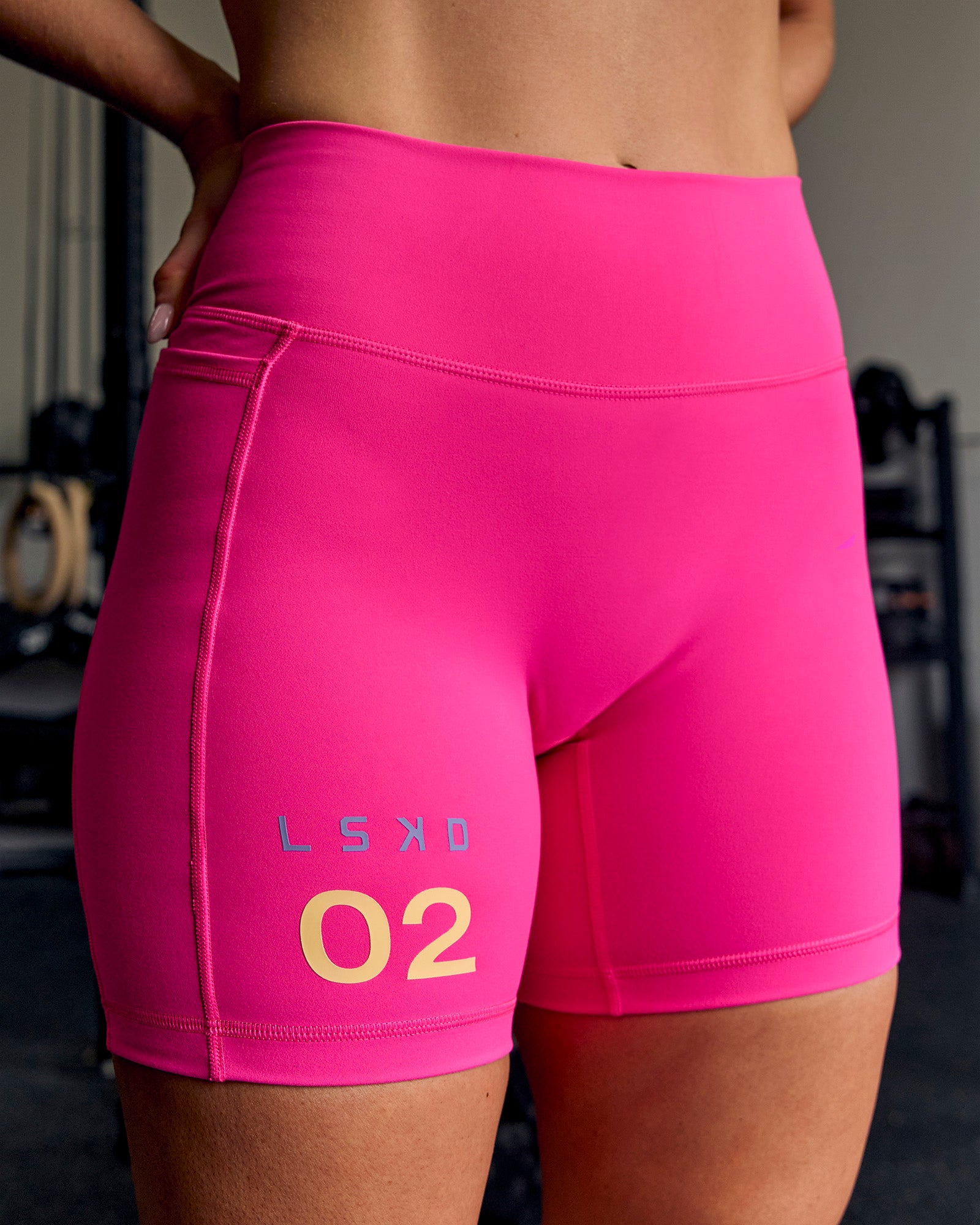 Woman wearing Fusion V-Contour High-Rise 6" Short Pockets - Ultra Pink-Tech Department