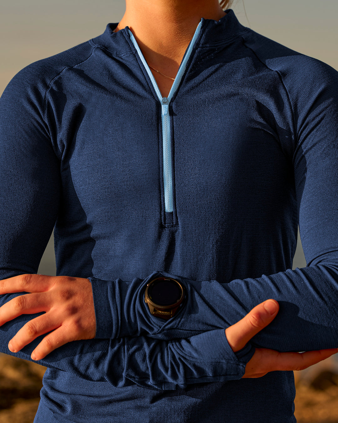 Woman wearing GG AeroFLX+ Long Sleeve Half Zip - Future Navy-Baltic Sea | Model:Grace | Size:XS
