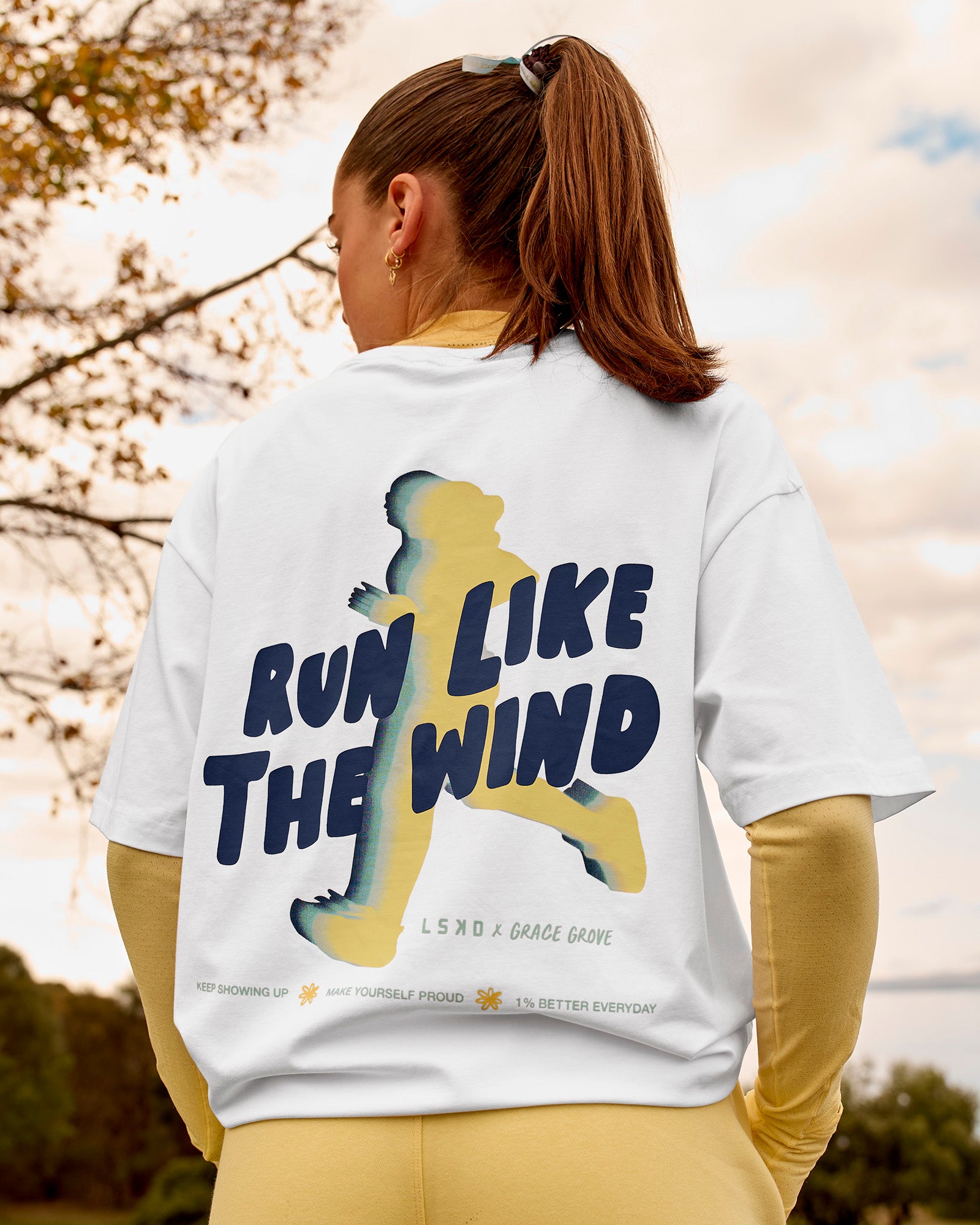 Woman wearing Woman wearing Run Like The Wind FLXCotton Oversized Tee - White-Future Navy | Model:Grace | Size:S