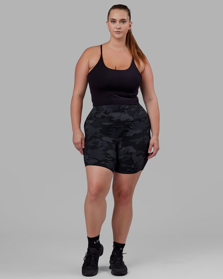 Woman wearing Elixir Mid Short Tight - Black Camo
