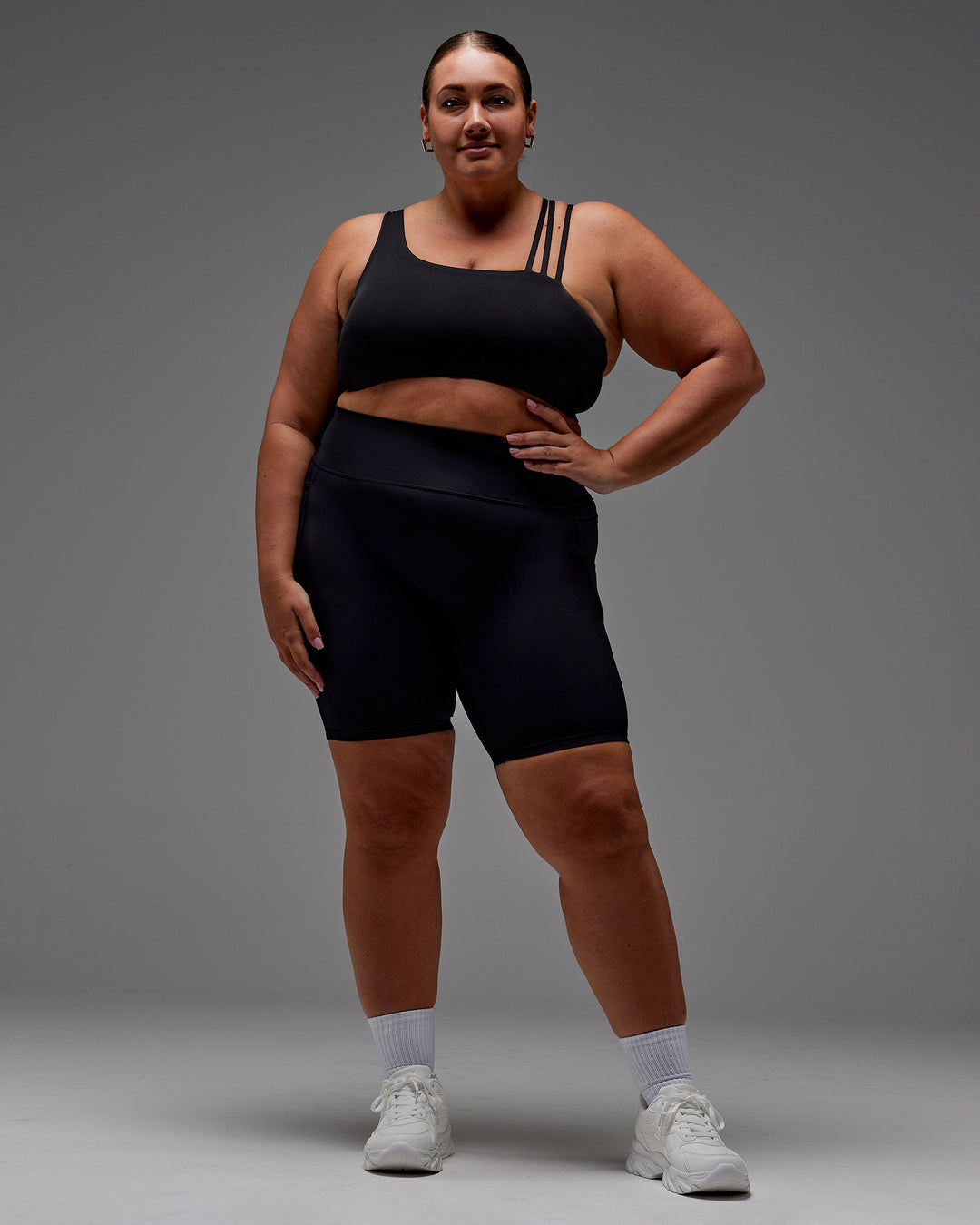 Woman wearing Fusion Ultra High-Rise 9&quot; Short Pockets - Black | Model:Jordie | Size:2XL