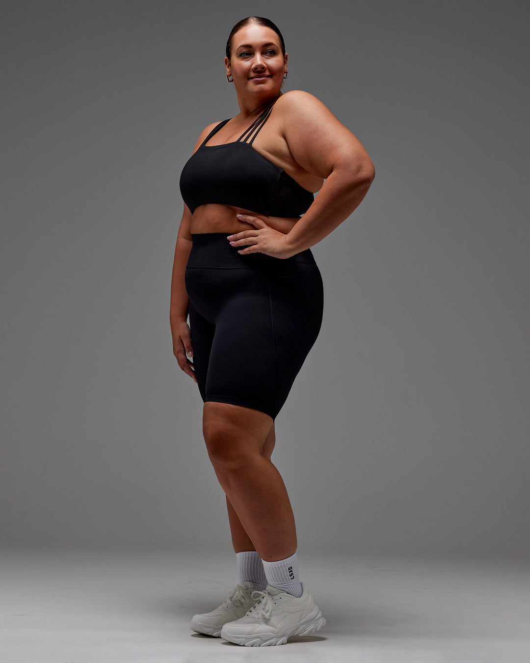 Woman wearing Fusion Ultra High-Rise 9&quot; Short Pockets - Black | Model:Jordie | Size:2XL