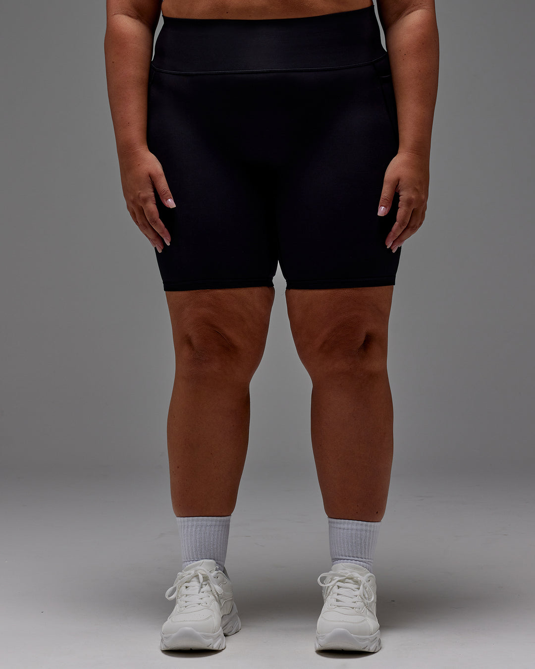Woman wearing Fusion Ultra High-Rise 9&quot; Short Pockets - Black | Model:Jordie | Size:2XL
