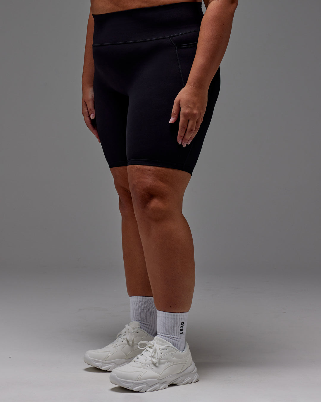 Woman wearing Fusion Ultra High-Rise 9&quot; Short Pockets - Black | Model:Jordie | Size:2XL