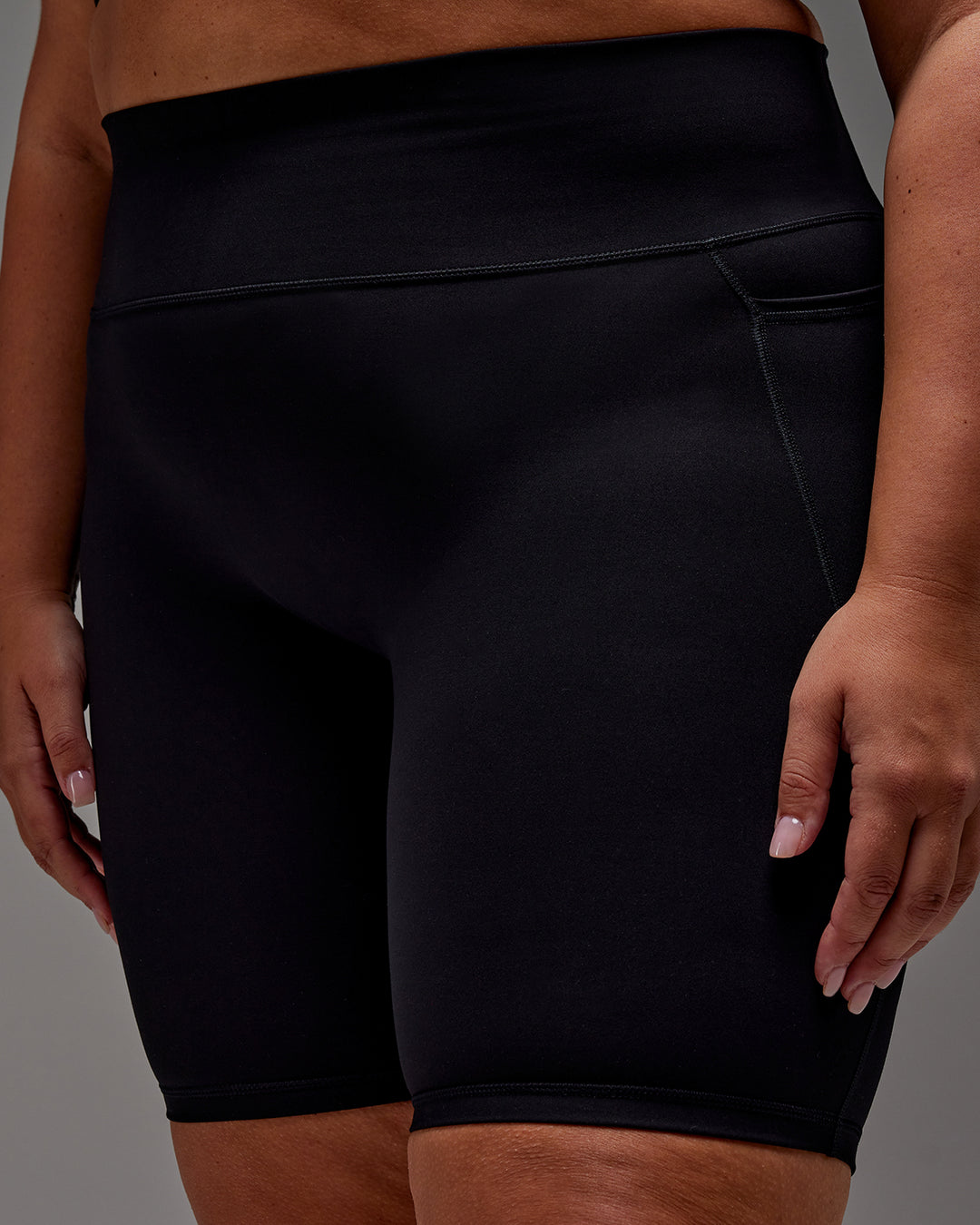 Woman wearing Fusion Ultra High-Rise 9&quot; Short Pockets - Black | Model:Jordie | Size:2XL