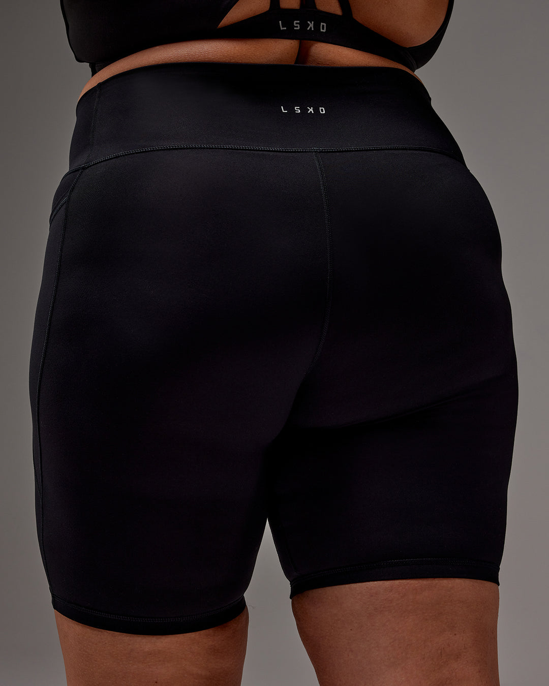 Woman wearing Fusion Ultra High-Rise 9&quot; Short Pockets - Black | Model:Jordie | Size:2XL