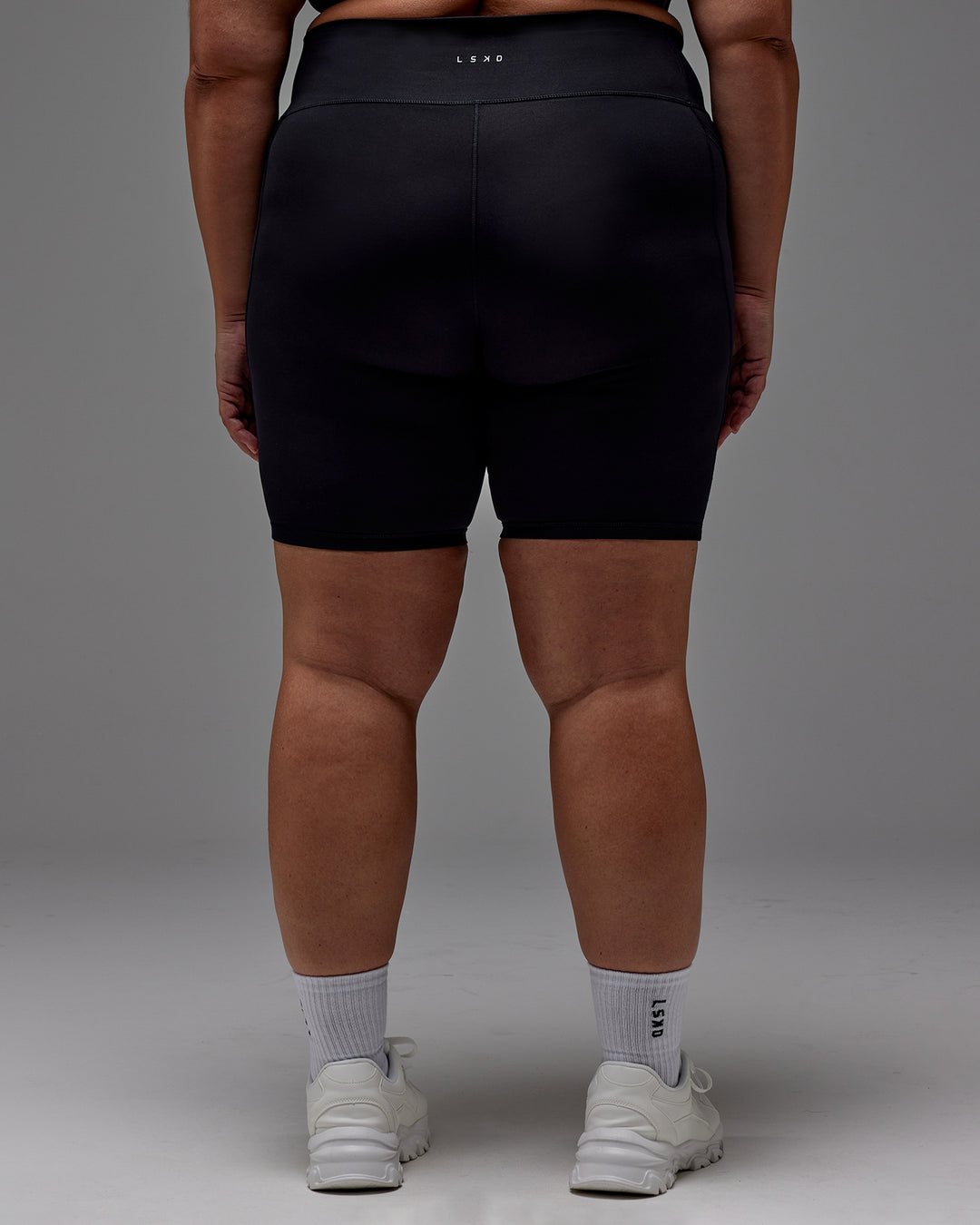 Woman wearing Fusion Ultra High-Rise 9&quot; Short Pockets - Black | Model:Jordie | Size:2XL