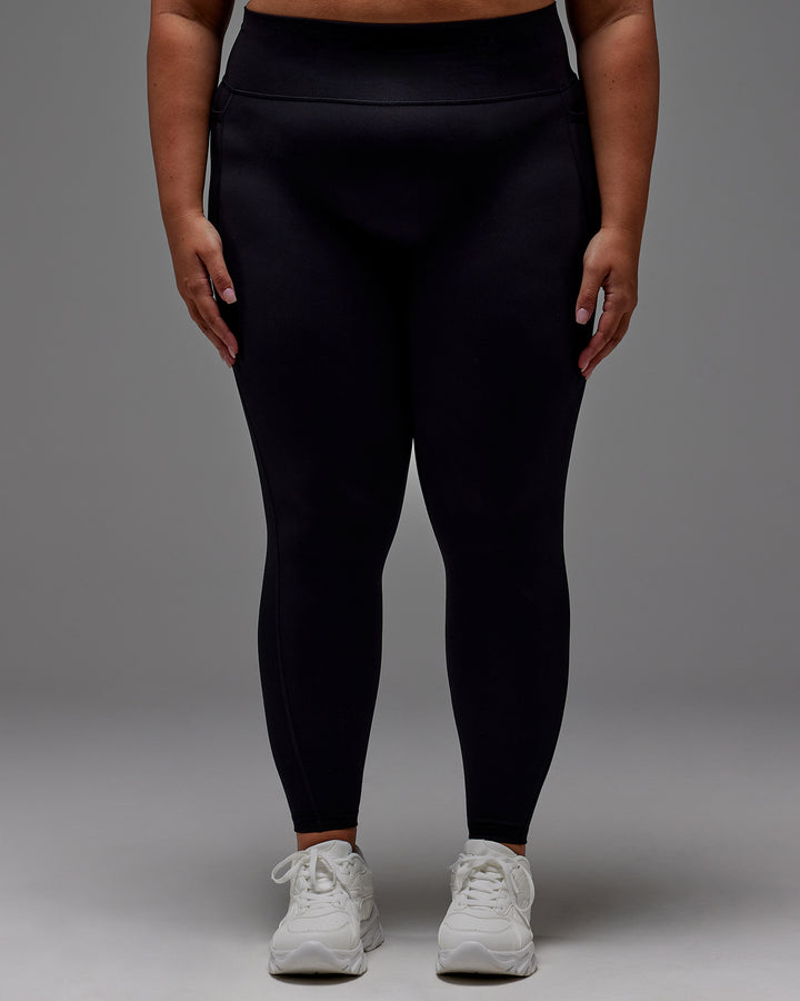 Woman wearing Fusion Full Length Tight With Pockets in Black | Model:Jordie | Size:2XL

