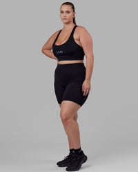 Woman wearing O.G. Fusion Ultra High-Rise 6" Short Pockets - Black | Model:Milly | Size:S