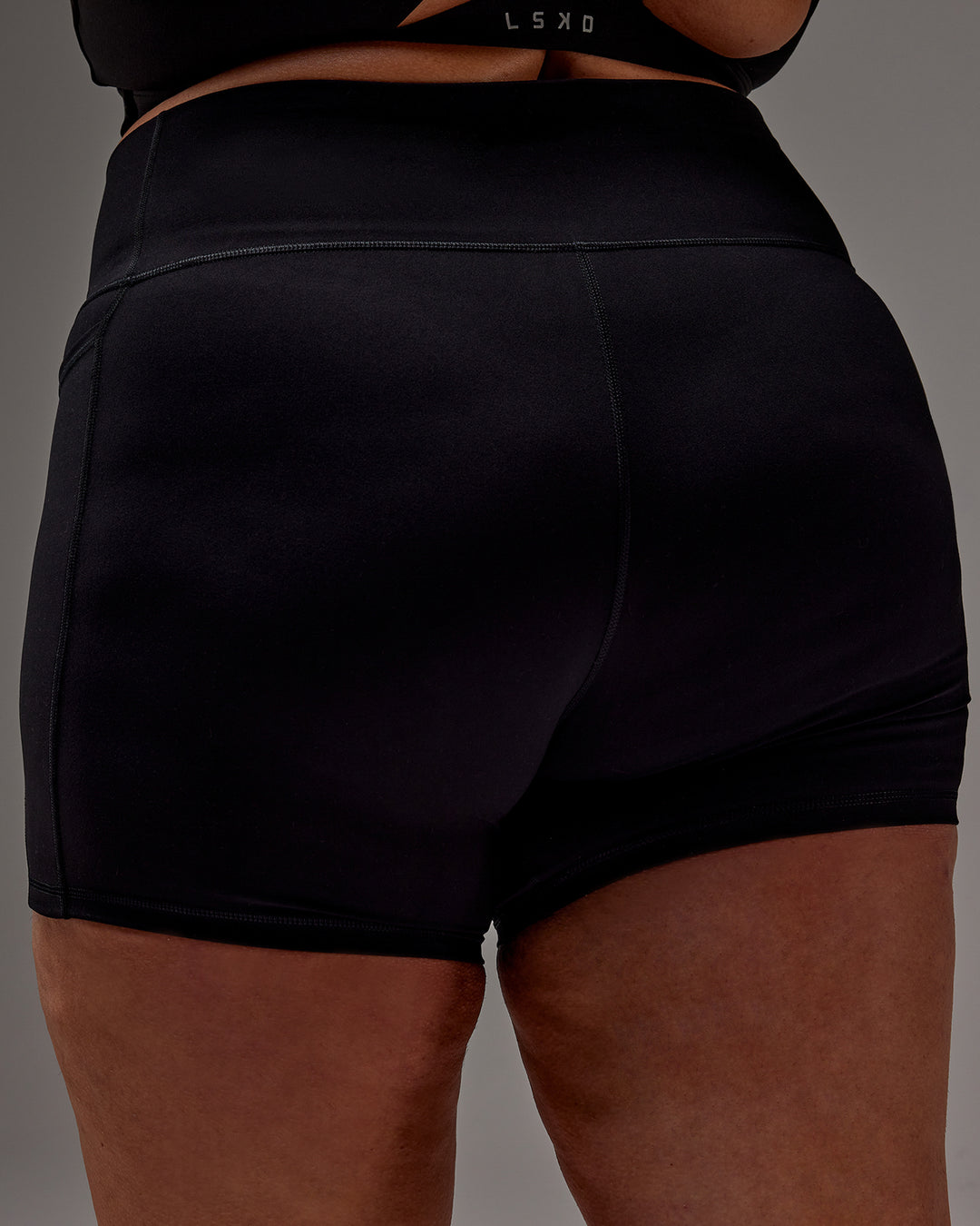 Woman wearing Fusion Ultra High-Rise 6&quot; Short Pockets - Black | Model:Jordie | Size:2XL
