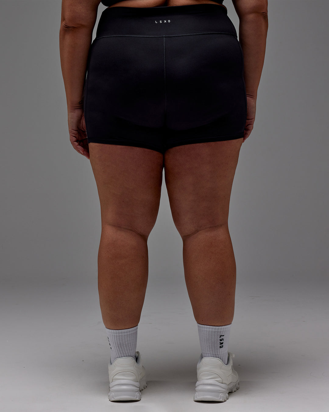 Woman wearing Fusion Ultra High-Rise 6&quot; Short Pockets - Black | Model:Jordie | Size:2XL