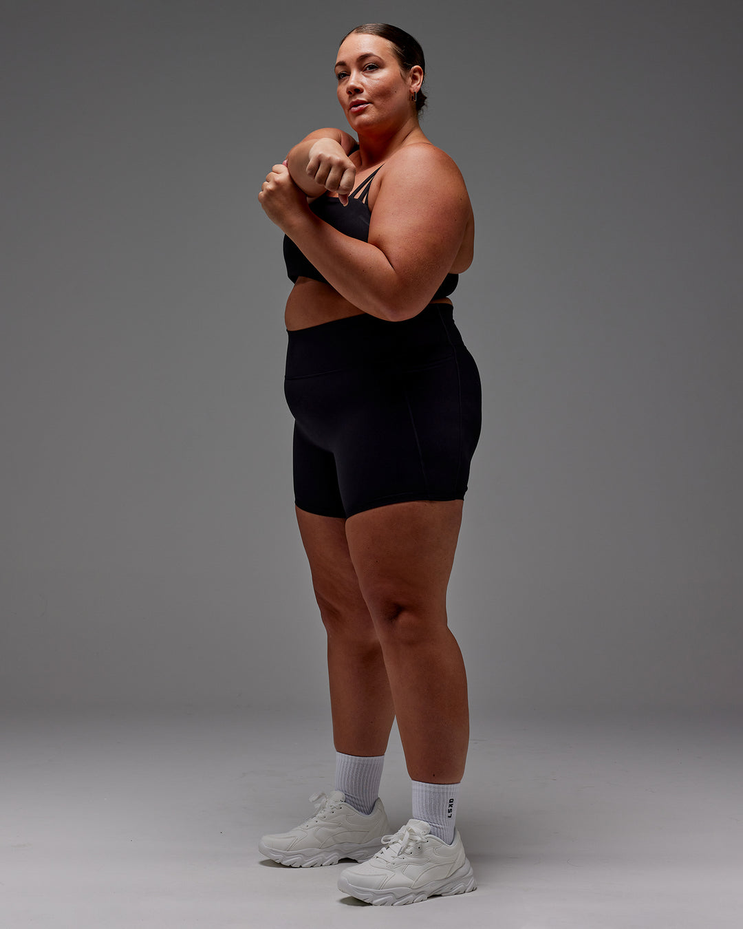 Woman wearing Fusion Ultra High-Rise 6&quot; Short Pockets - Black | Model:Jordie | Size:2XL