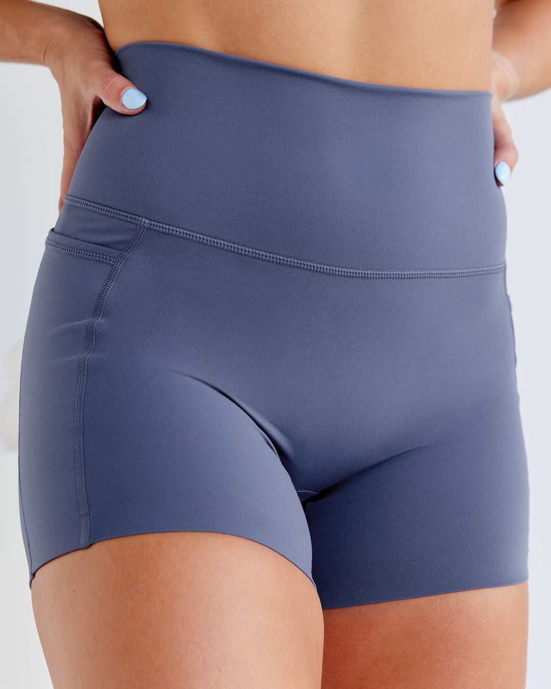 Woman wearing Abs Elixir Ultra High-Rise 4&quot; Short Pockets - Nightshadow Blue