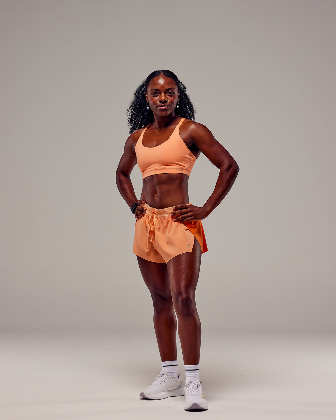 Woman wearing Accelerate 3" Run Shorts - Cantaloupe Colourblock