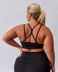 Woman wearing Bridge Sports Bra - Black-White