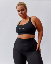 Woman wearing Bridge Sports Bra - Black-White