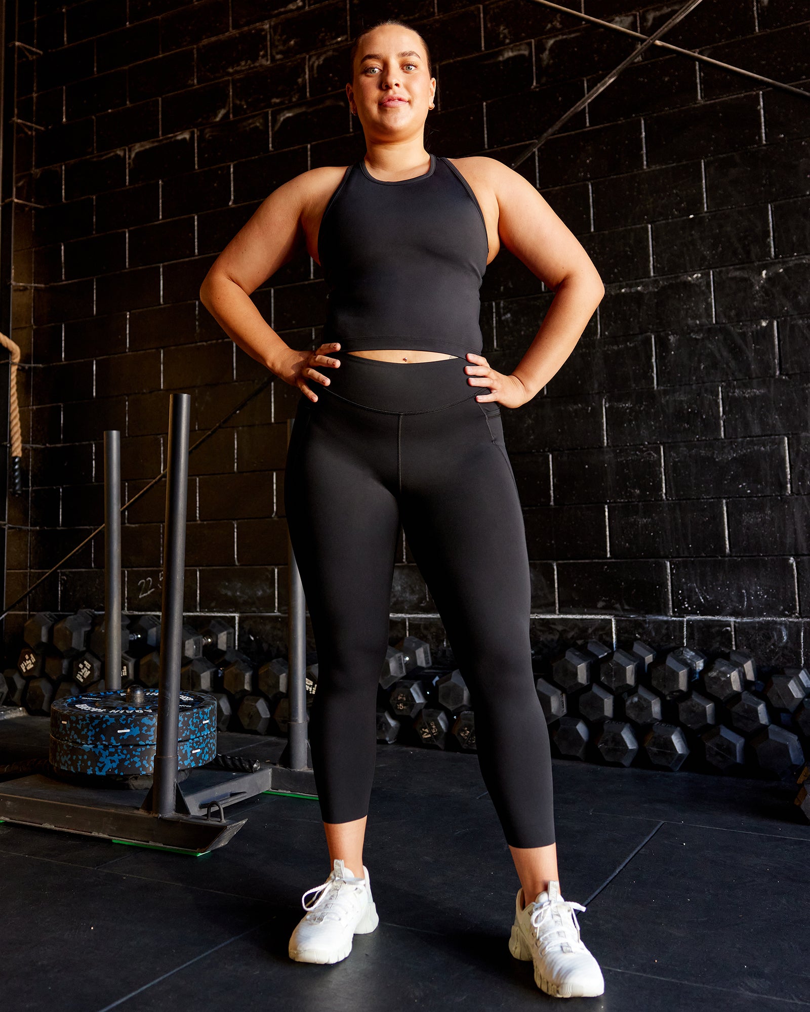 Woman wearing Elite High-Rise 7/8 Legging Pockets - Black