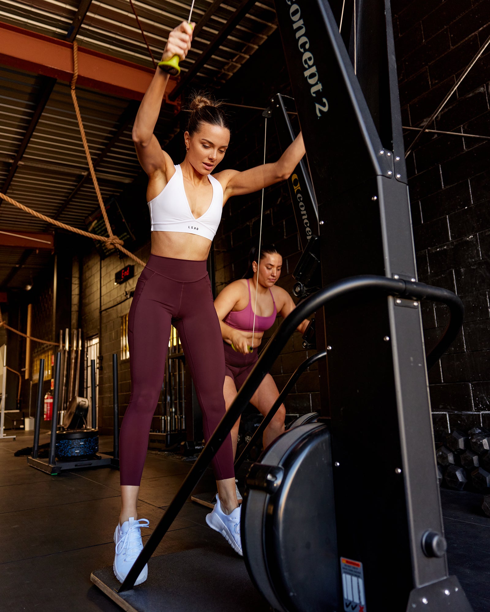 Woman wearing Elite High-Rise 7/8 Legging Pockets - Dark Cherry