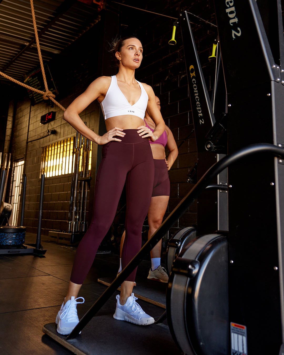 Woman wearing Elite High-Rise 7/8 Legging Pockets - Dark Cherry