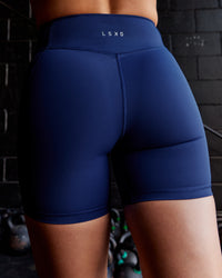 Woman wearing Elite High-Rise 6" Short Pockets - Midnight Blue