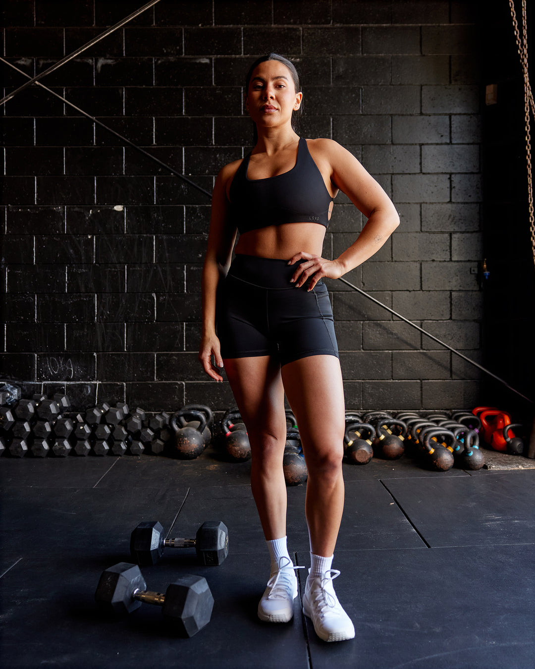 Woman wearing Elite High-Rise 4&quot; Short Pockets - Black