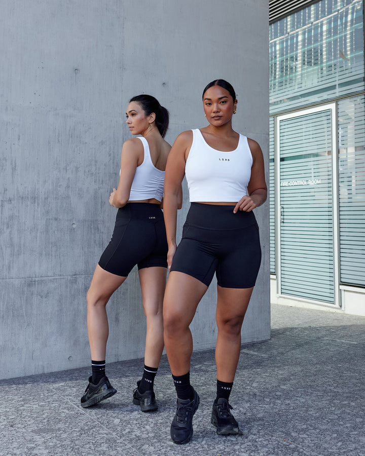 Woman wearing Elixir Mid Short Tight with Pockets - Black