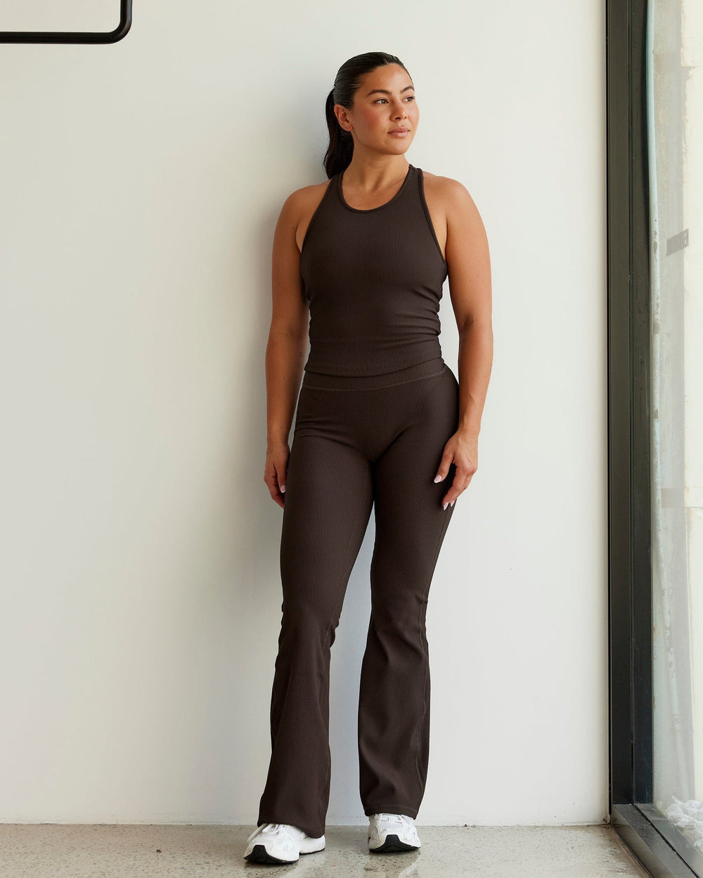 Woman wearing Flow Ribbed Shelf Bra Performance Tank - Dark Chocolate