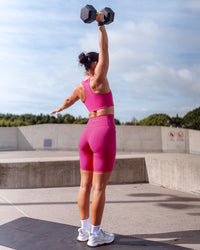 Woman wearing Fusion Ultra High-Rise 9" Short Pockets - Fuchsia Pink | Model:Emily | Size:S