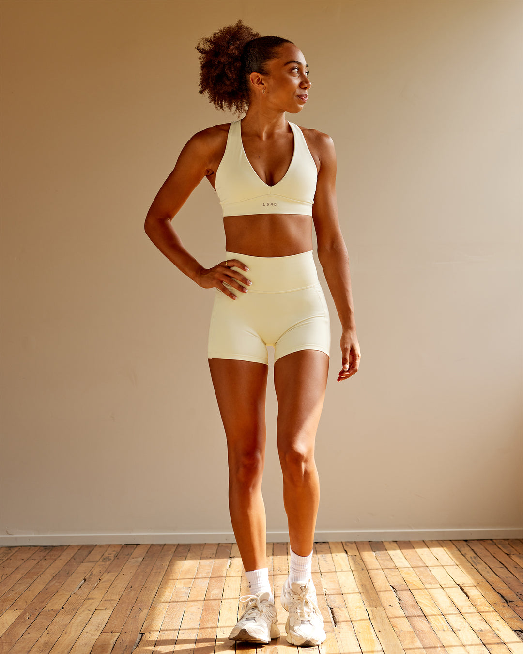 Woman wearing Fusion Ultra High-Rise 4&quot; Short Pockets - Ivory | Model:Txai | Size:XS