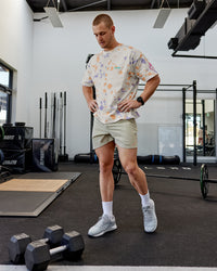Man wearing Lift 6" Performance Shorts - Sand-So Cal 24