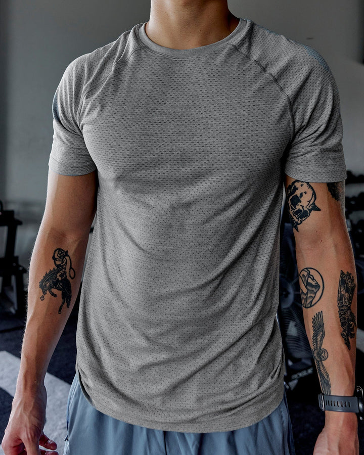 Man wearing AeroFLX+ Seamless Tee - Light Grey Marl

