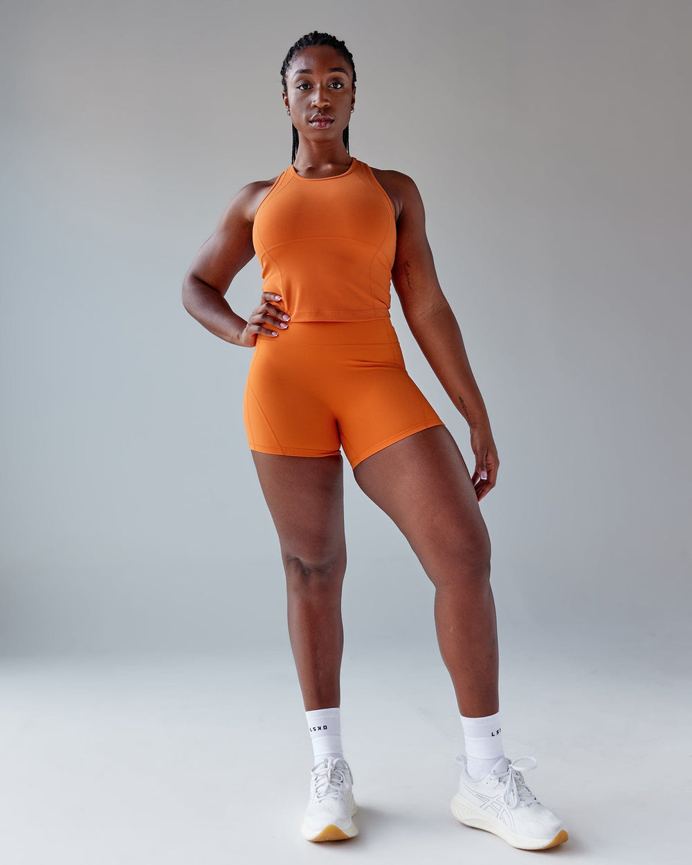 Woman wearing Propel Performance Tank - Burnt Orange