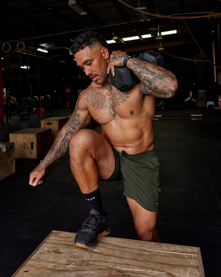 Man wearing Rep 5'' Performance Short - Forest Night-Lime