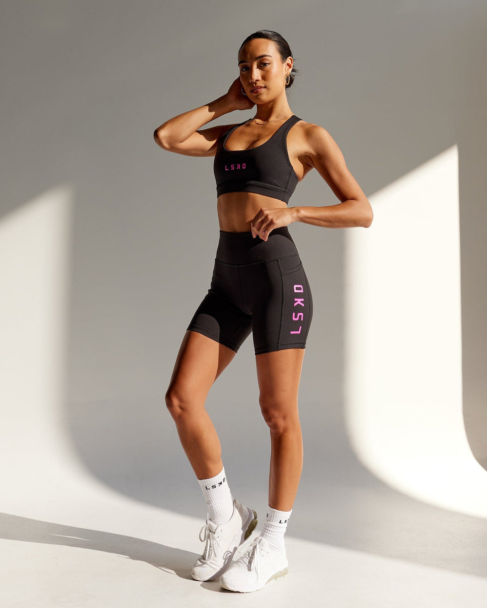 Woman wearing Rep Mid Short Tight - Black-Neon Magenta