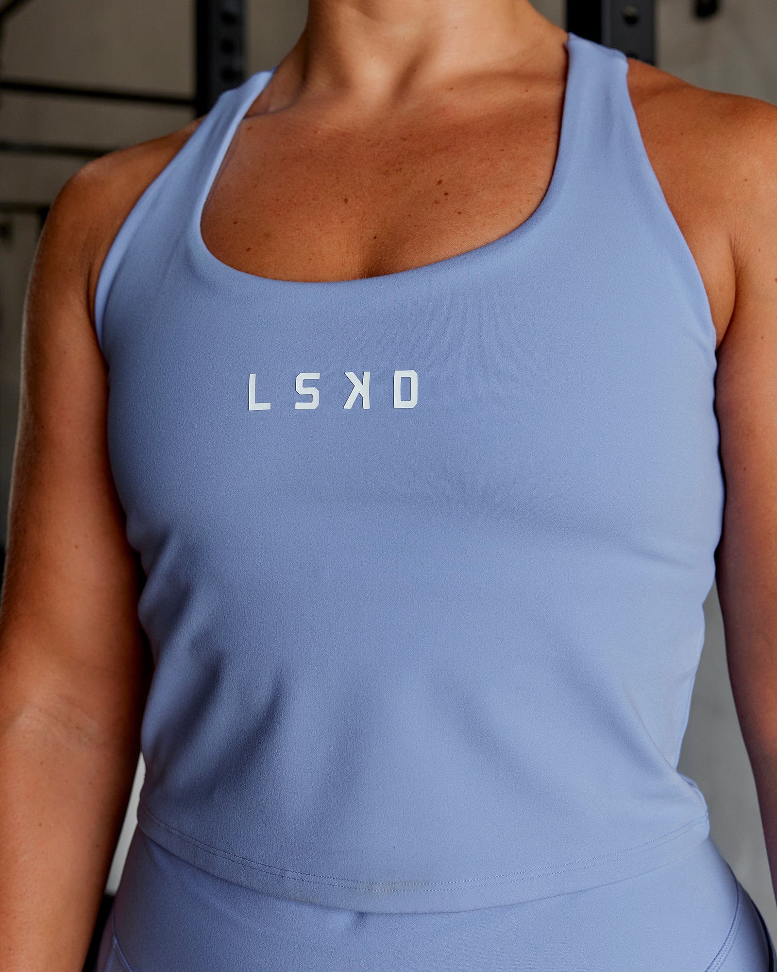 Woman wearing Rep Shelf Bra Performance Tank - Arctic Blue