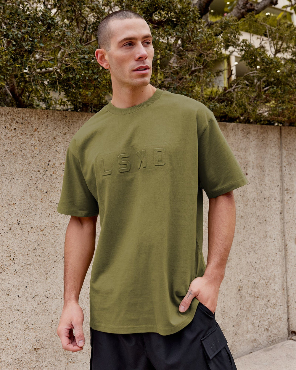 Man wearing Unisex Stamped Heavyweight Tee Oversize - Moss Stone