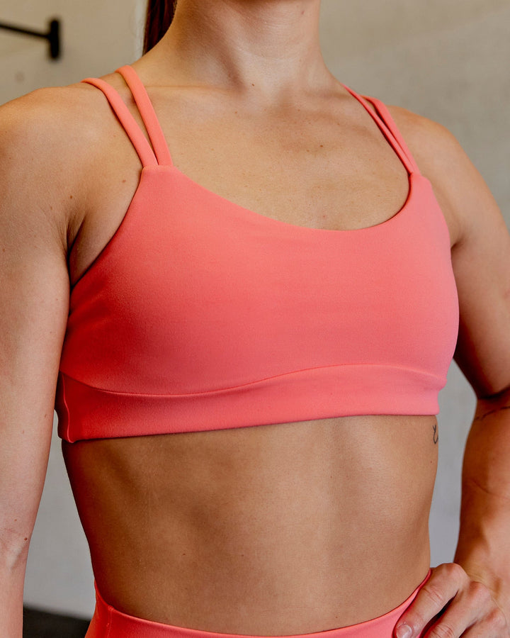Woman wearing Structure Sports Bra - Coral